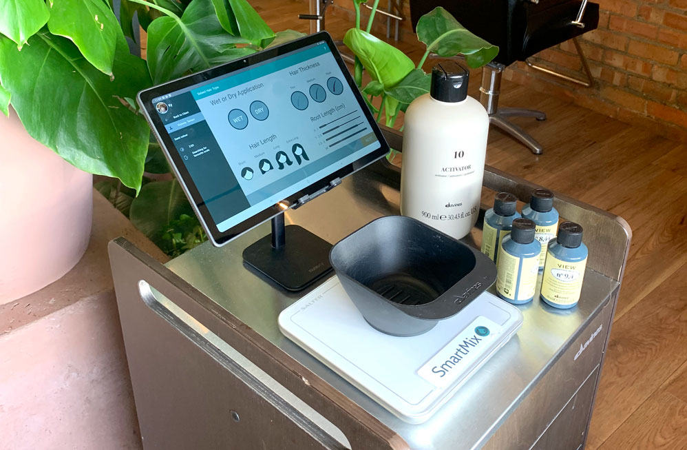Photo of the app running on a tablet in a salon setting